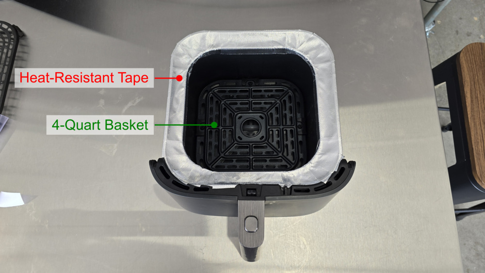 Photograph of the 33% smaller food basket mounted inside that of the Cosori using heat-resistant tape.